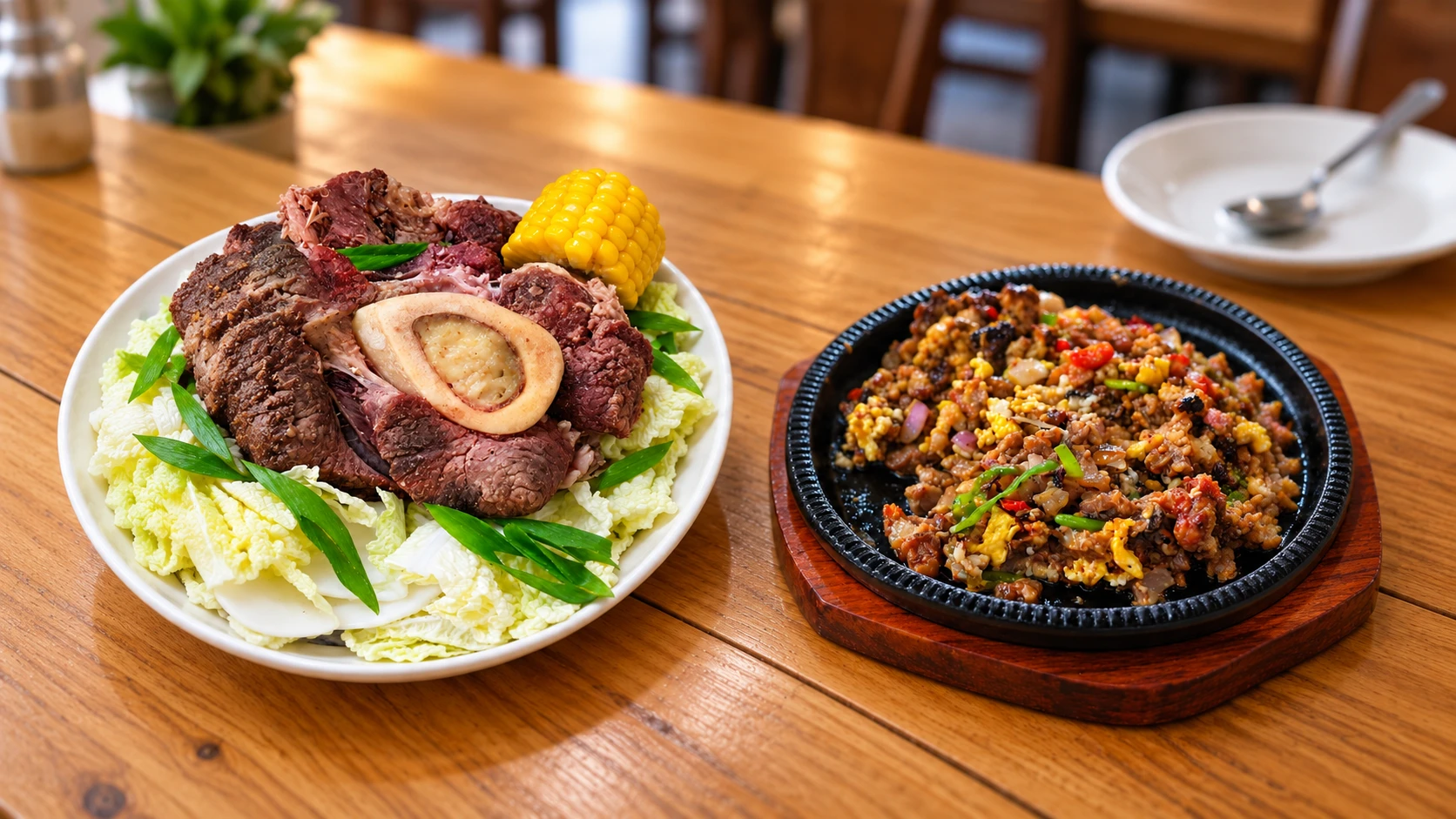 Bulalo with tender beef, bone marrow, cabbage, and corn served beside sizzling sisig at Kristine Bulalo at Sisig.