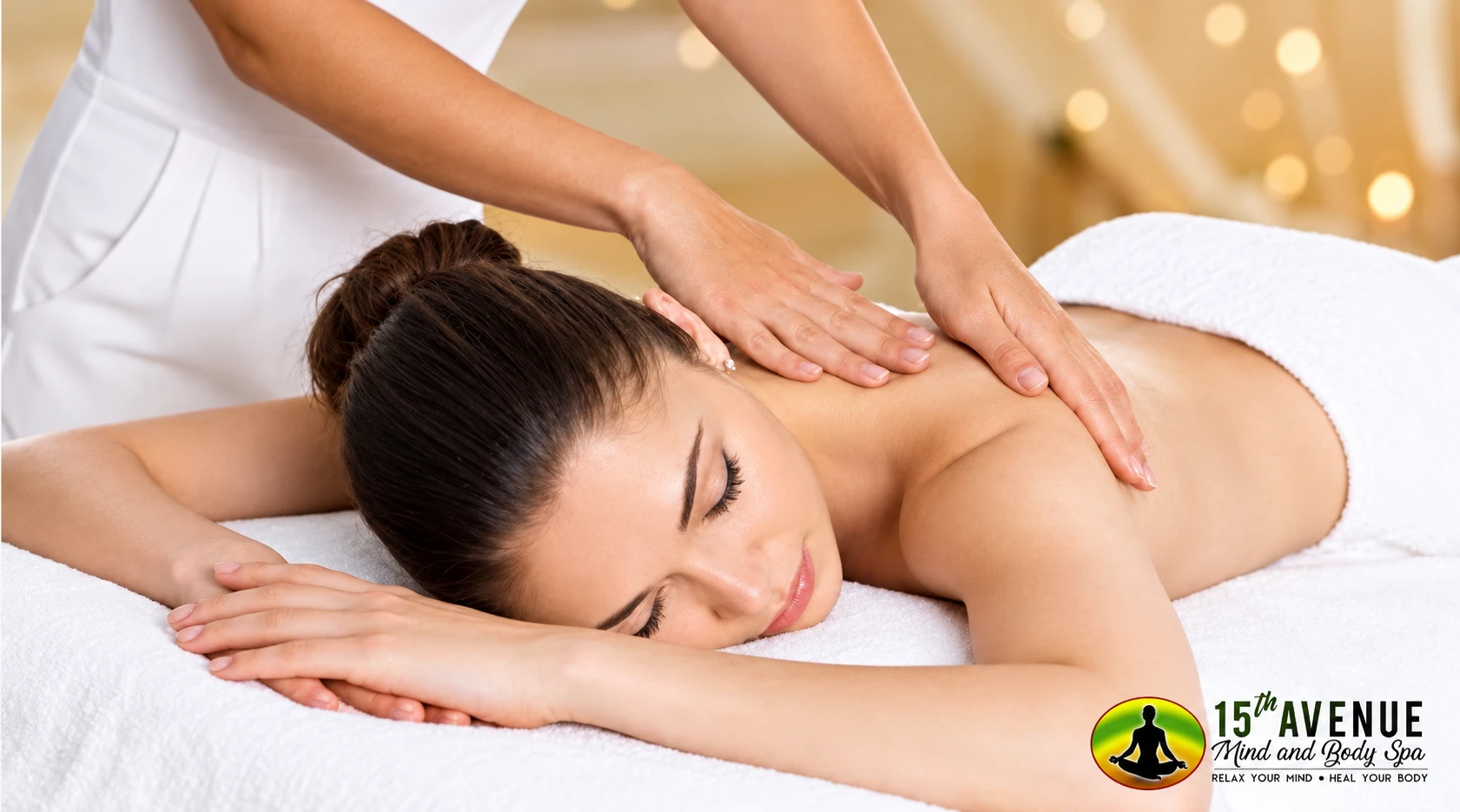 Woman receiving a relaxing back and shoulder massage at 15th Avenue Mind & Body Spa.