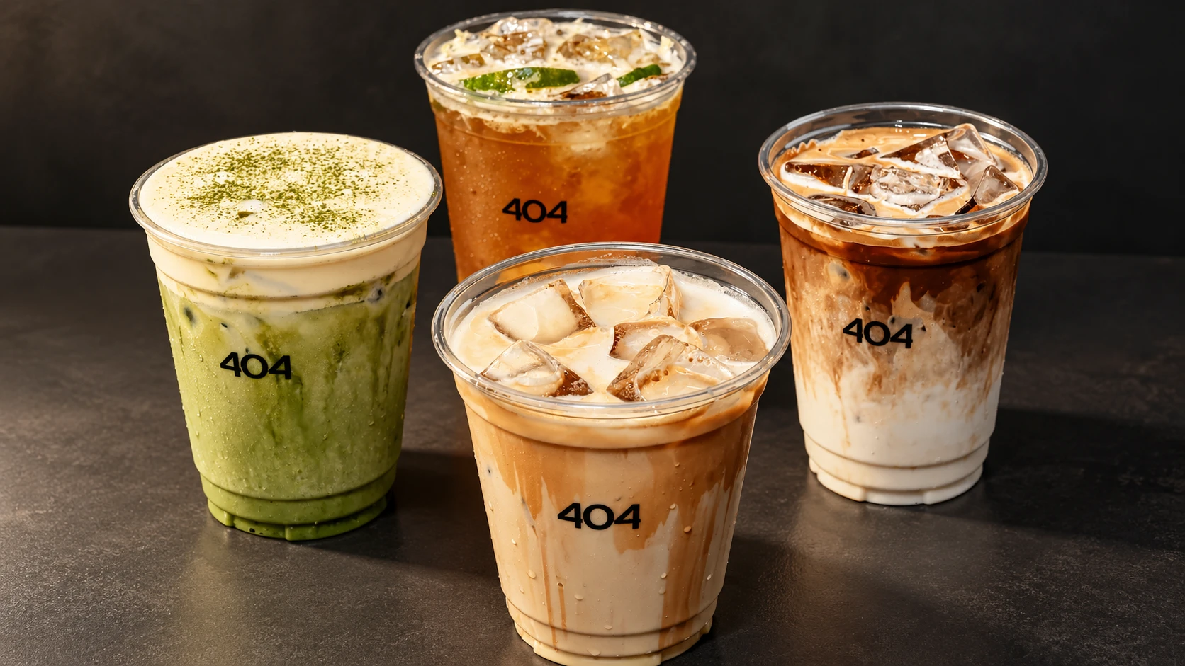 Four iced drinks from 404 Not Found, including matcha, tea, and creamy coffee beverages, displayed against a dark background.
